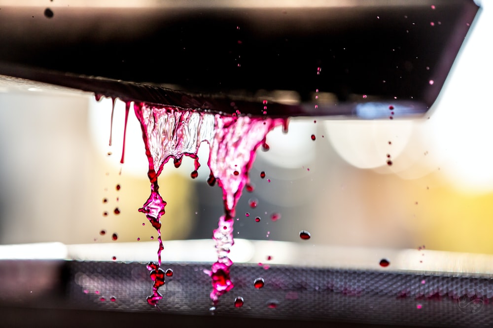 timelapse photography of dripping purple liquid