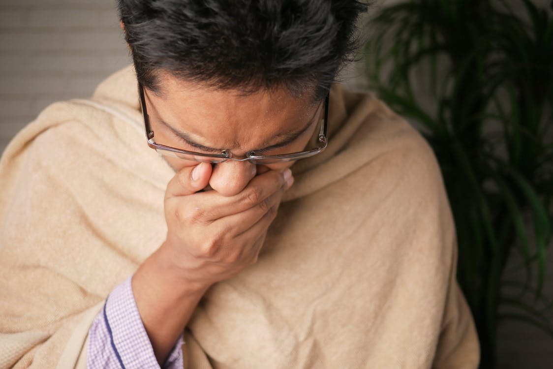 Free Close-Up Photo of a Sick Man Covering His Mouth Stock Photo